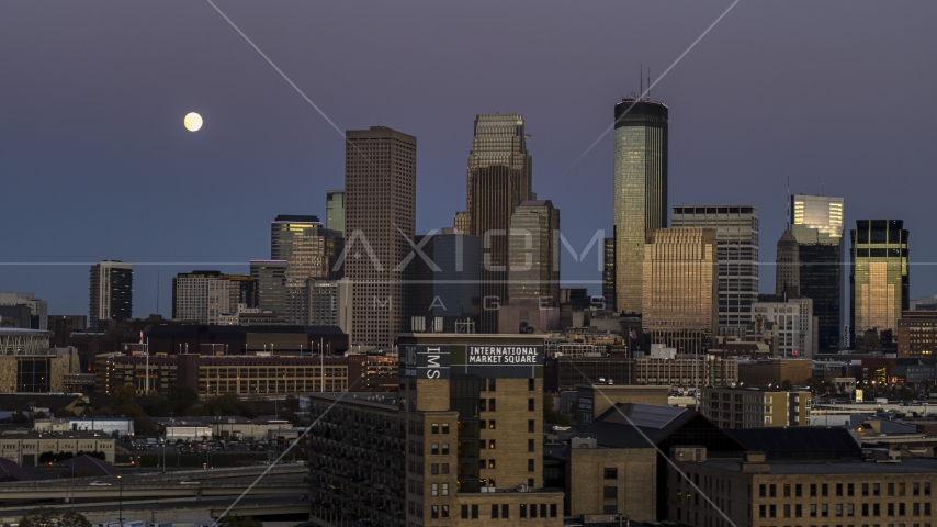 The moon above tall skyscrapers of the city's skyline at twilight, Downtown Minneapolis, Minnesota Aerial Stock Photo DXP001_000337 | Axiom Images