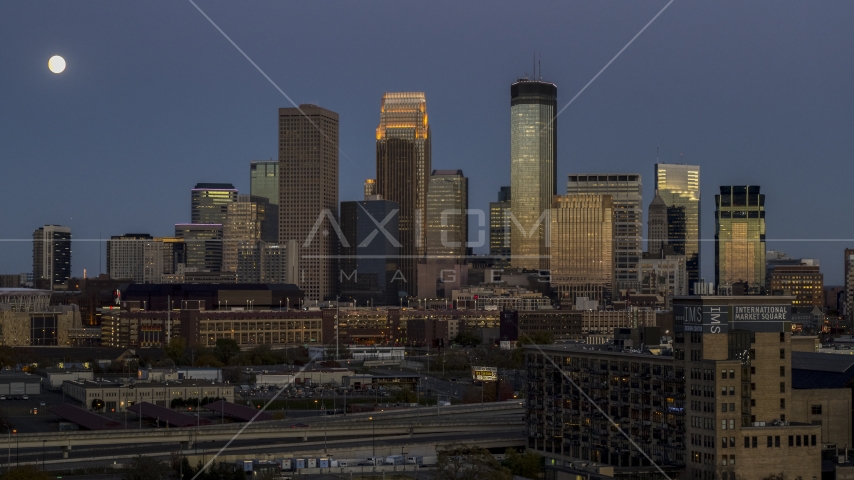 A view of the city's skyline at twilight, moon beside skyscrapers, Downtown Minneapolis, Minnesota Aerial Stock Photo DXP001_000345 | Axiom Images