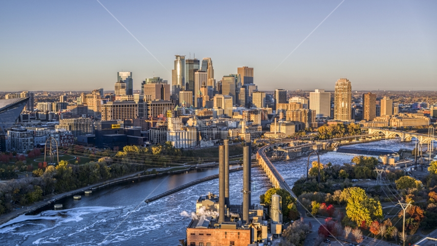 The city's skyline seen from power plant by the Mississippi River at sunrise, Downtown Minneapolis, Minnesota Aerial Stock Photo DXP001_000356 | Axiom Images