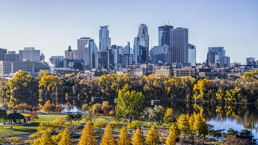 The city's skyline seen from the river lined with autumn trees, Downtown Minneapolis, Minnesota Aerial Stock Photo DXP001_000360 | Axiom Images