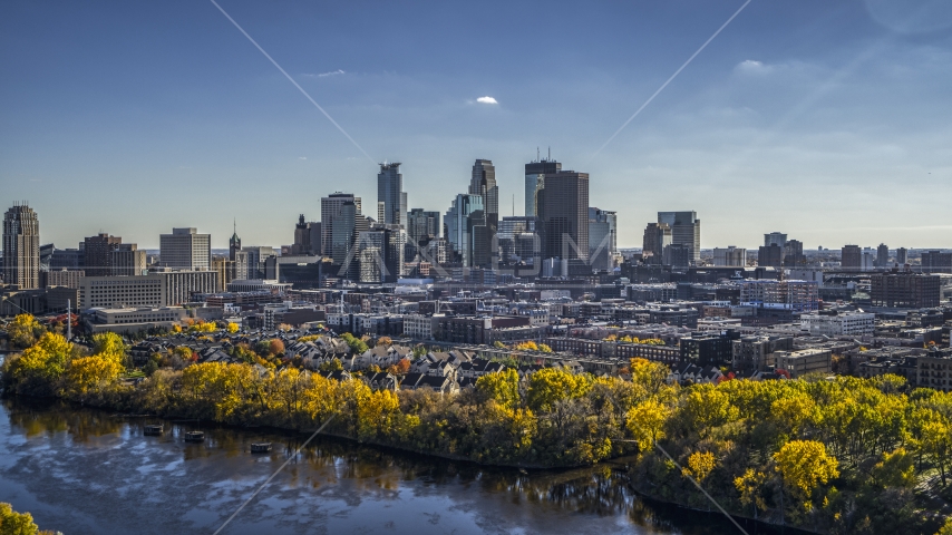 City skyline's skyscrapers seen from the Mississippi River with autumn trees, Downtown Minneapolis, Minnesota Aerial Stock Photo DXP001_000396 | Axiom Images