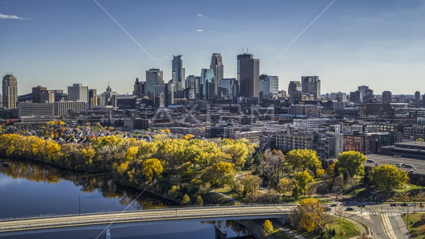 A view of the city skyline from the Mississippi River with fall trees, Downtown Minneapolis, Minnesota Aerial Stock Photo DXP001_000400 | Axiom Images