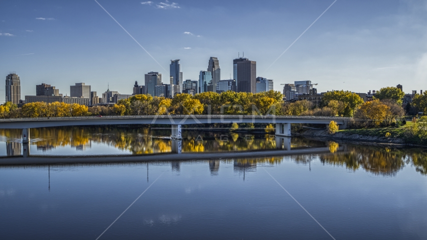 A view of the city skyline from near a bridge over the Mississippi River with fall trees, Downtown Minneapolis, Minnesota Aerial Stock Photo DXP001_000401 | Axiom Images