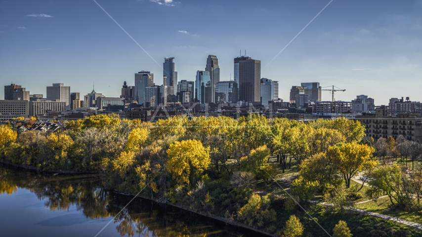A view of skyscrapers in the city skyline from the Mississippi River with fall trees, Downtown Minneapolis, Minnesota Aerial Stock Photo DXP001_000402 | Axiom Images