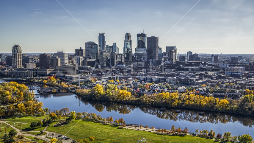 A view across the Mississippi River with fall trees at the city's skyline, Downtown Minneapolis, Minnesota Aerial Stock Photo DXP001_000403 | Axiom Images