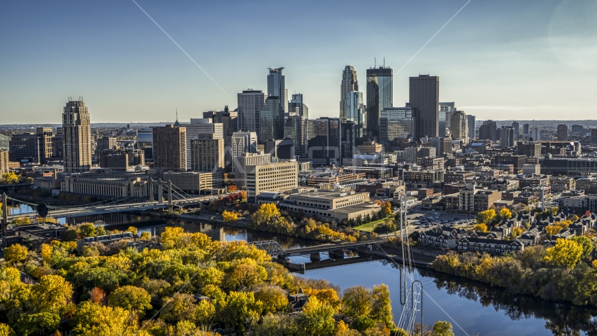 Bridges spanning the river near autumn trees, and the skyline in the background, Downtown Minneapolis, Minnesota Aerial Stock Photo DXP001_000411 | Axiom Images