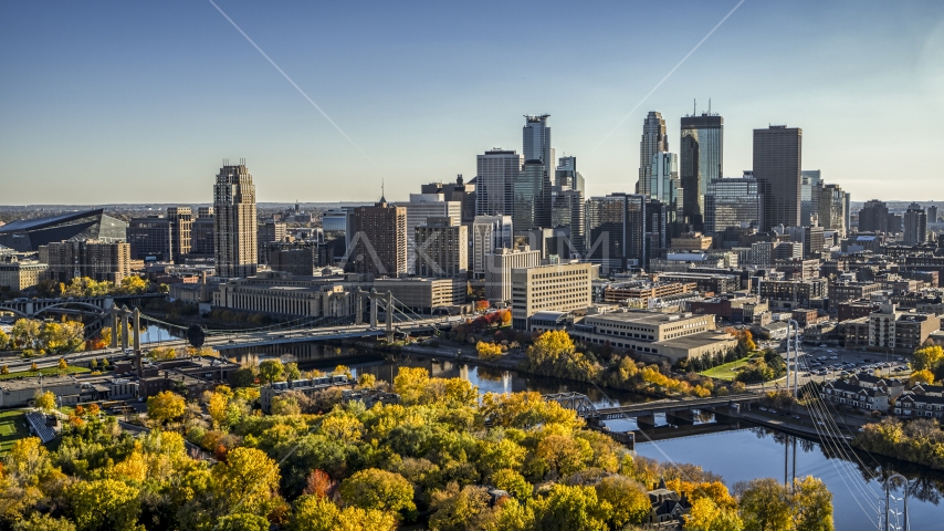 Bridges spanning the river near fall trees, and the skyline in the background, Downtown Minneapolis, Minnesota Aerial Stock Photo DXP001_000412 | Axiom Images