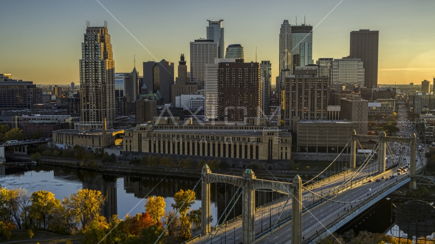 Skyline seen from the Hennepin Avenue Bridge crossing the river at sunset, Downtown Minneapolis, Minnesota Aerial Stock Photo DXP001_000415 | Axiom Images