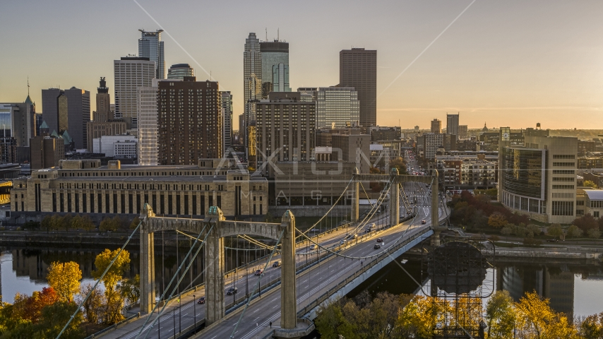 Cars crossing the Hennepin Avenue Bridge spanning the river at sunset, skyline in the distance, Downtown Minneapolis, Minnesota Aerial Stock Photo DXP001_000418 | Axiom Images