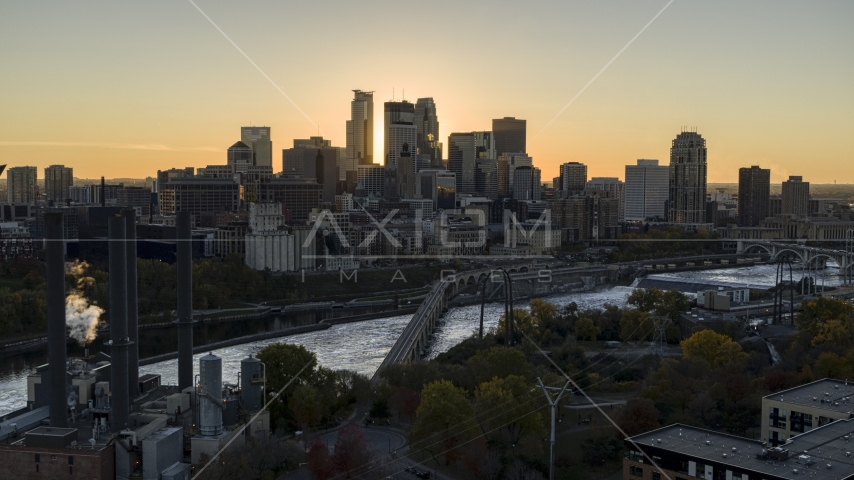The sun setting behind the skyline across the Mississippi River, Downtown Minneapolis, Minnesota Aerial Stock Photo DXP001_000423 | Axiom Images