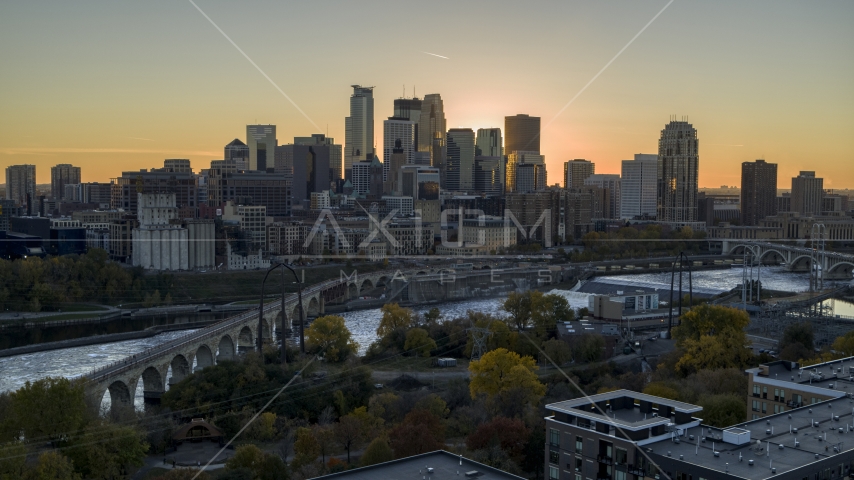 The city skyline across the river at sunset, seen from the Stone Arch Bridge, Downtown Minneapolis, Minnesota Aerial Stock Photo DXP001_000427 | Axiom Images