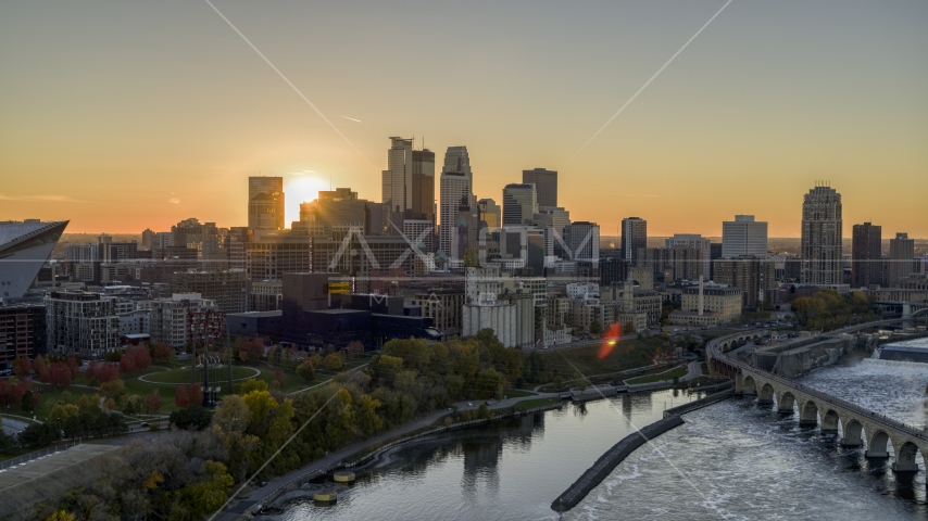 The city skyline on the other side of the river at sunset, seen from near a bridge, Downtown Minneapolis, Minnesota Aerial Stock Photo DXP001_000428 | Axiom Images
