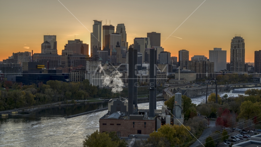 The city skyline on the other side of the river at sunset, seen from power plant, Downtown Minneapolis, Minnesota Aerial Stock Photo DXP001_000429 | Axiom Images