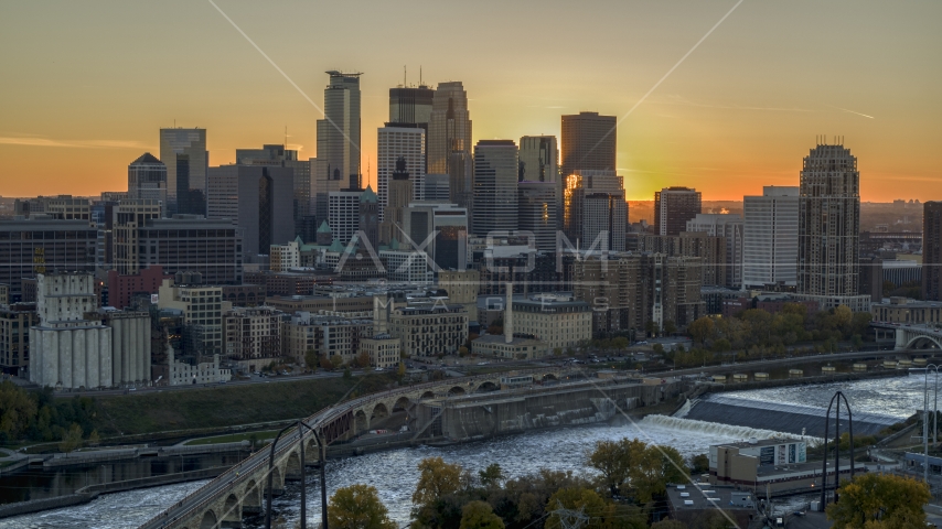 The city skyline on the other side of the bridge and river at sunset, Downtown Minneapolis, Minnesota Aerial Stock Photo DXP001_000430 | Axiom Images