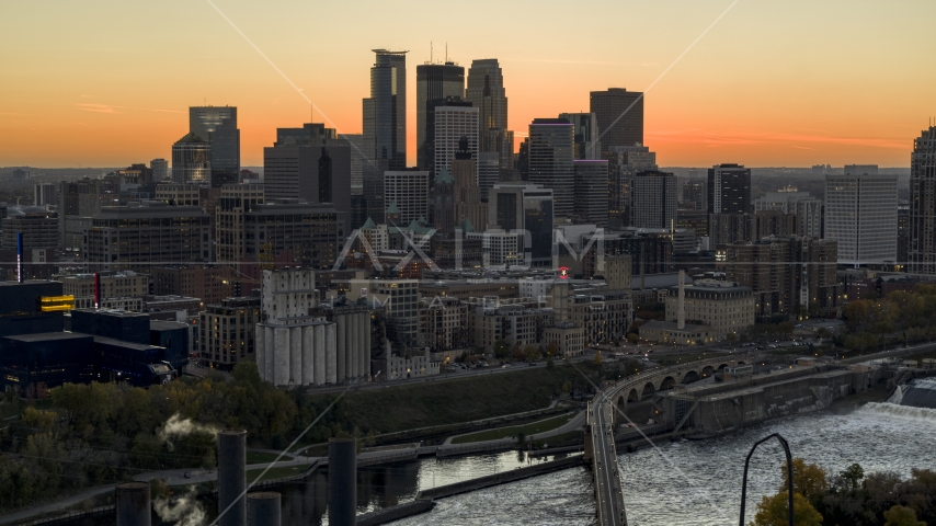 The downtown skyline on the other side of the river at sunset, Downtown Minneapolis, Minnesota Aerial Stock Photo DXP001_000434 | Axiom Images