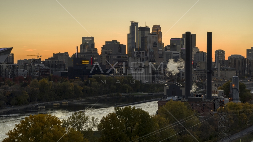 The downtown skyline at sunset, seen from smoke stacks by the river, Downtown Minneapolis, Minnesota Aerial Stock Photo DXP001_000436 | Axiom Images