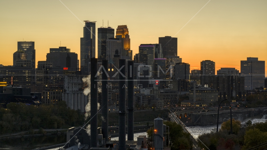 The downtown skyline at twilight, seen from smoke stacks near the river, Downtown Minneapolis, Minnesota Aerial Stock Photo DXP001_000437 | Axiom Images
