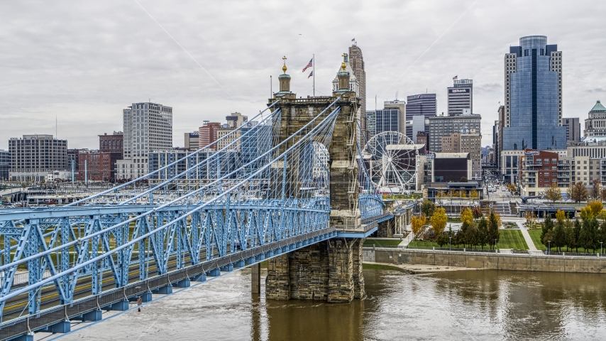 The Roebling Bridge spanning the Ohio River with the city skyline in the background, Downtown Cincinnati, Ohio Aerial Stock Photo DXP001_000469 | Axiom Images