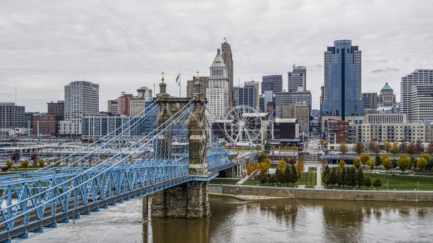 The side of the Roebling Bridge with Ferris wheel and skyline in the background, Downtown Cincinnati, Ohio Aerial Stock Photo DXP001_000471 | Axiom Images