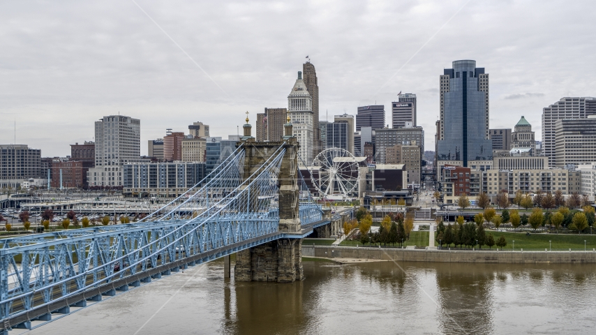 The side of the Roebling Bridge with the Ferris wheel and skyline in the distance, Downtown Cincinnati, Ohio Aerial Stock Photo DXP001_000472 | Axiom Images