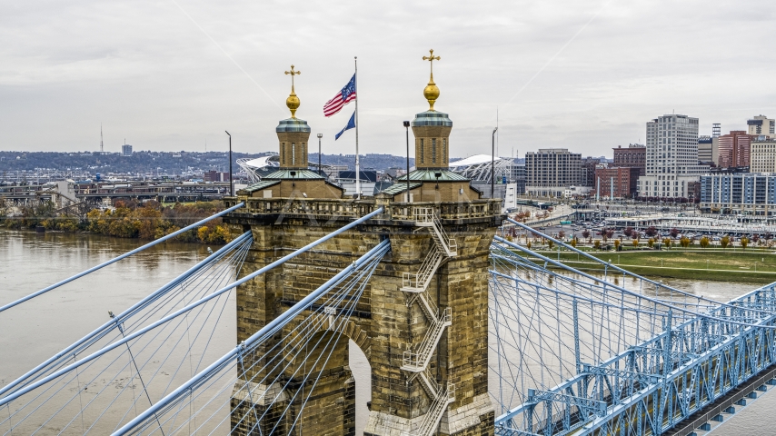 Flag on top of the Roebling Bridge spanning the Ohio River, Downtown Cincinnati, Ohio Aerial Stock Photo DXP001_000473 | Axiom Images
