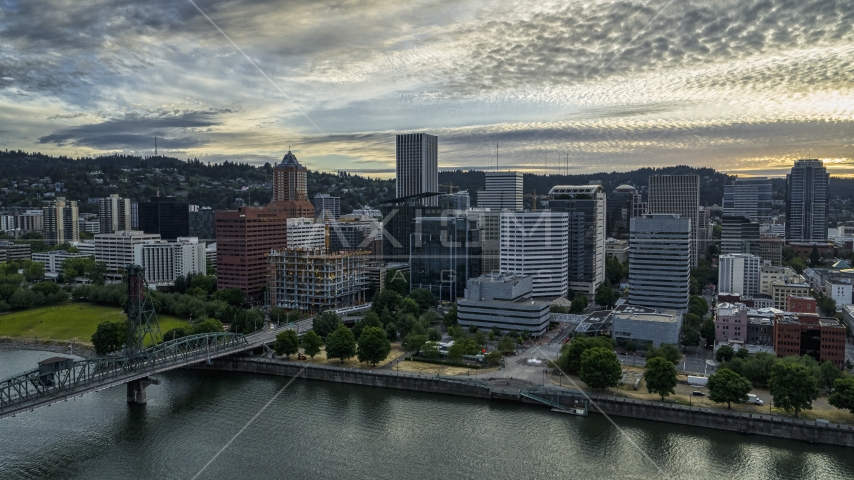 Waterfront office buildings by the river at sunset in Downtown Portland, Oregon Aerial Stock Photo DXP001_014_0003 | Axiom Images