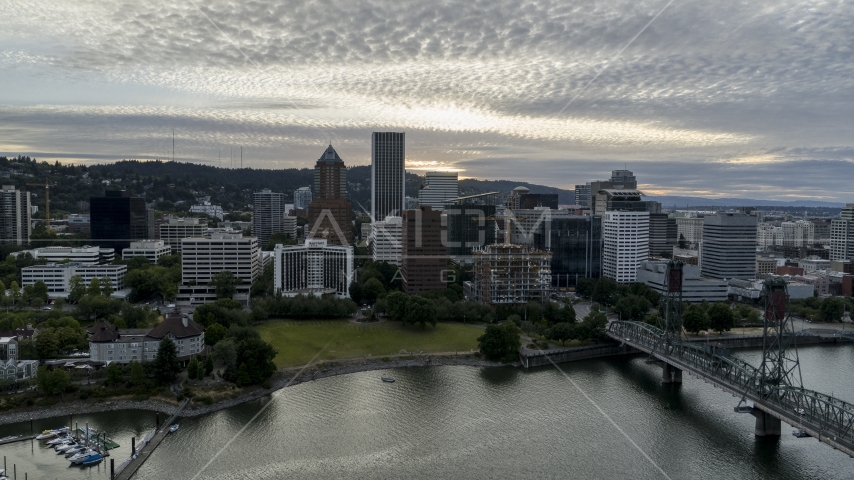 The city skyline seen from the Willamette River at sunset in Downtown Portland, Oregon Aerial Stock Photo DXP001_014_0004 | Axiom Images