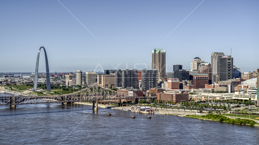 Riverfront office buildings near a bridge with Arch in the background, Downtown St. Louis, Missouri Aerial Stock Photo DXP001_023_0009 | Axiom Images