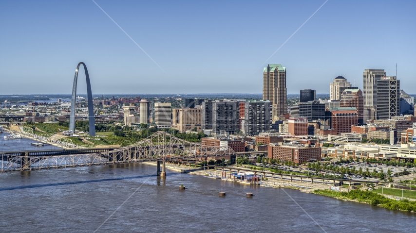 A view of riverfront office buildings near a bridge with Arch in the background, Downtown St. Louis, Missouri Aerial Stock Photo DXP001_024_0002 | Axiom Images