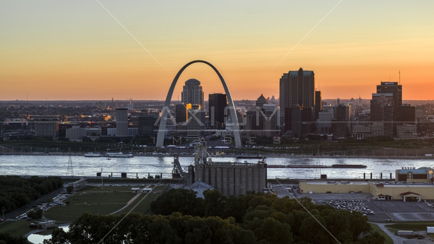 A view across the river of the Gateway Arch and Downtown St. Louis skyline, Missouri at sunset Aerial Stock Photo DXP001_029_0003 | Axiom Images