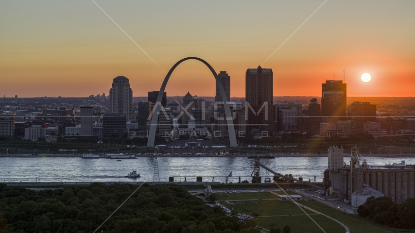 The setting sun behind the Gateway Arch and Downtown St. Louis, Missouri Aerial Stock Photo DXP001_029_0005 | Axiom Images