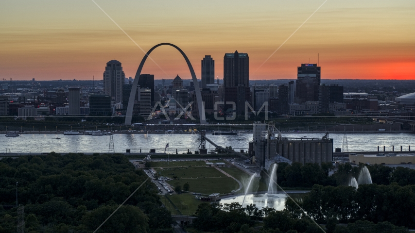 Gateway Arch across the river, seen from grain elevator and fountains, Downtown St. Louis, Missouri, twilight Aerial Stock Photo DXP001_029_0013 | Axiom Images