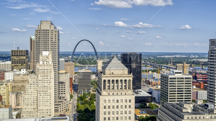 The Gateway Arch seen between skyscrapers and a courthouse tower in Downtown St. Louis, Missouri Aerial Stock Photo DXP001_031_0007 | Axiom Images