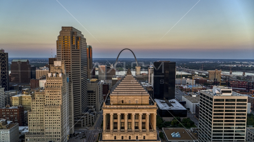 A view over the top of a courthouse to the Gateway Arch at twilight, Downtown St. Louis, Missouri Aerial Stock Photo DXP001_036_0005 | Axiom Images