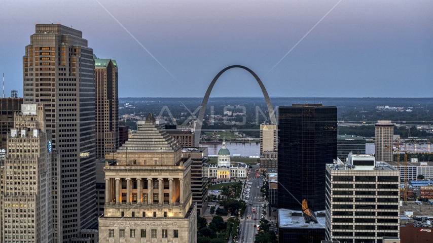 A view of the Gateway Arch and museum at twilight seen across Downtown St. Louis, Missouri Aerial Stock Photo DXP001_036_0013 | Axiom Images