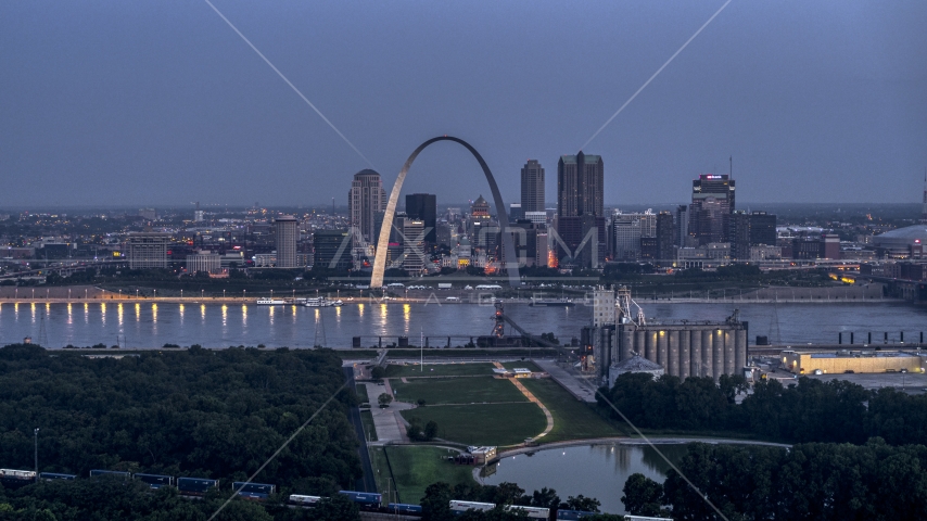 The Gateway Arch at twilight, visible from across the Mississippi River, Downtown St. Louis, Missouri Aerial Stock Photo DXP001_037_0001 | Axiom Images