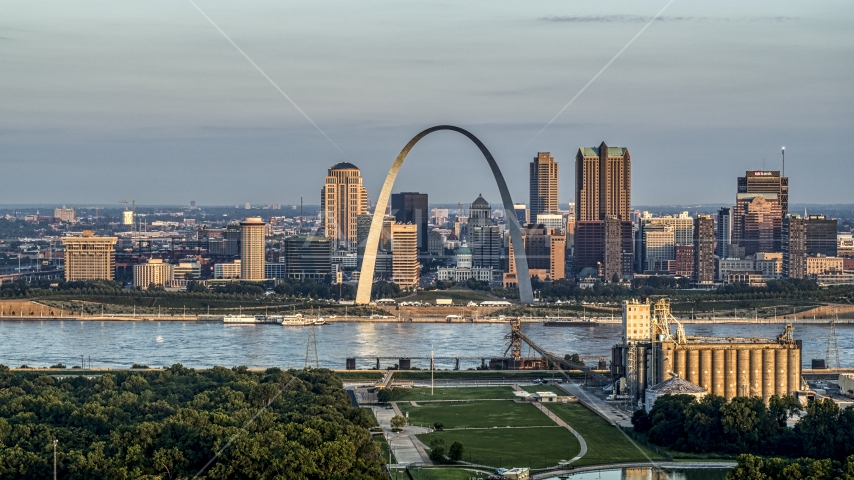 The St. Louis Arch beside the river at sunrise in Downtown St. Louis, Missouri Aerial Stock Photo DXP001_038_0006 | Axiom Images