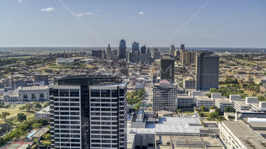The city skyline behind tall Crown Center office buildings, Downtown Kansas City, Missouri Aerial Stock Photo DXP001_044_0002 | Axiom Images