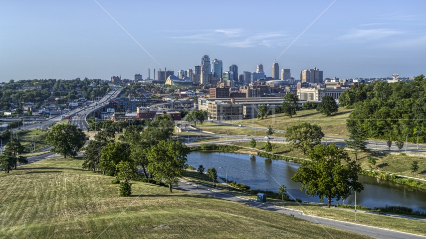 The city's skyline seen from green lawns beside a small lake, Kansas City, Missouri Aerial Stock Photo DXP001_045_0005 | Axiom Images