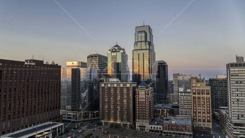 A downtown hotel and tall city skyscrapers at twilight in Downtown Kansas City, Missouri Aerial Stock Photo DXP001_051_0016 | Axiom Images