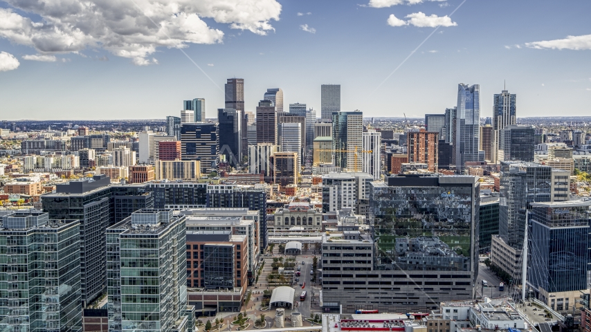The city's skyline behind office buildings in Downtown Denver, Colorado Aerial Stock Photo DXP001_055_0004 | Axiom Images