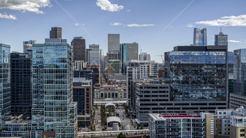 The city's skyline behind office buildings in Downtown Denver, Colorado Aerial Stock Photo DXP001_055_0007 | Axiom Images