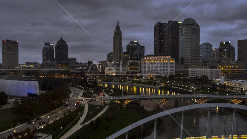The city skyline at twilight seen from the river and bridges in Downtown Columbus, Ohio Aerial Stock Photo DXP001_087_0011 | Axiom Images