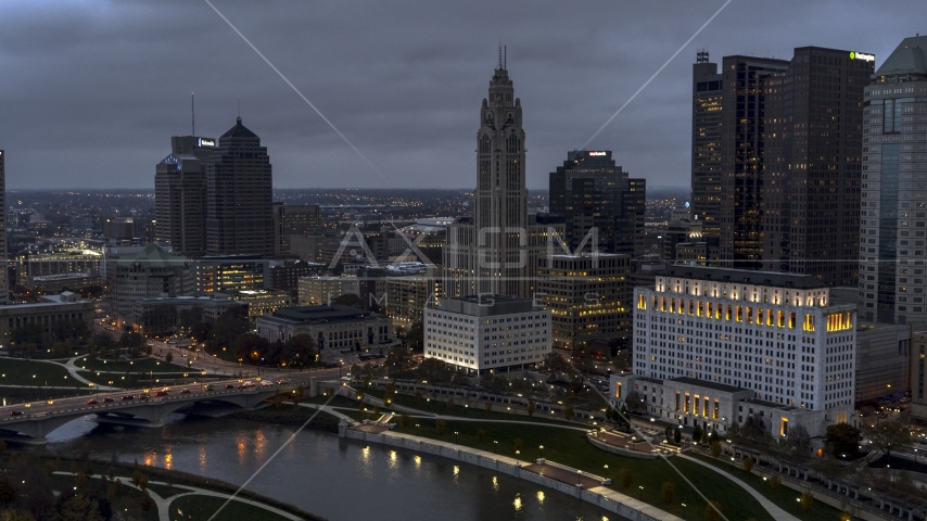 A view of LeVeque Tower across the river at twilight, Downtown Columbus, Ohio Aerial Stock Photo DXP001_087_0012 | Axiom Images