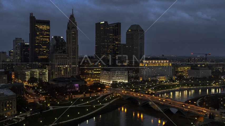 The city's skyline beside a bridge and river at twilight, Downtown Columbus, Ohio Aerial Stock Photo DXP001_088_0006 | Axiom Images