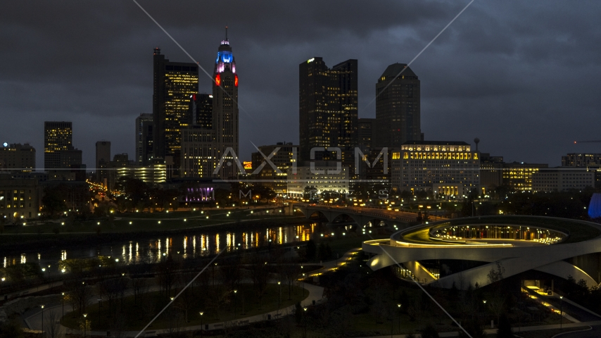 The city skyline's tall skyscrapers across the river at twilight, Downtown Columbus, Ohio Aerial Stock Photo DXP001_088_0011 | Axiom Images