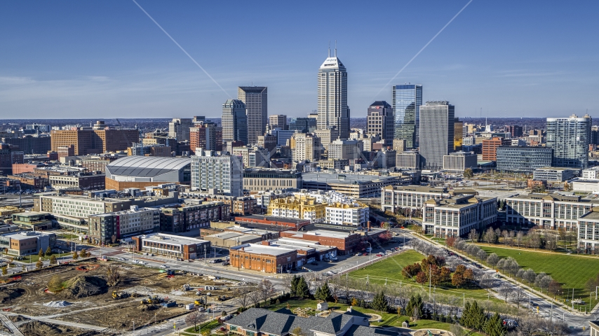 The city's skyline in Downtown Indianapolis, Indiana seen from smaller brick buildings Aerial Stock Photo DXP001_090_0005 | Axiom Images