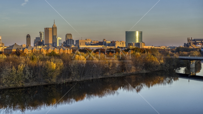 The city's skyline at sunset, seen from low over White River, Downtown Indianapolis, Indiana Aerial Stock Photo DXP001_092_0008 | Axiom Images