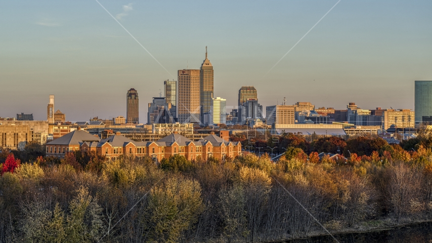 The city's skyline at sunset, seen from trees and apartment complex, Downtown Indianapolis, Indiana Aerial Stock Photo DXP001_092_0009 | Axiom Images
