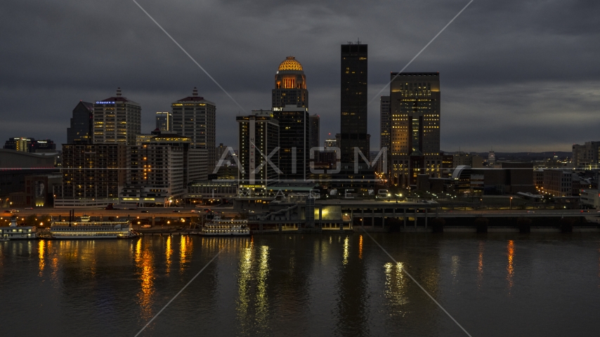 Tall skyscrapers lit up for the night in Downtown Louisville, Kentucky Aerial Stock Photo DXP001_096_0013 | Axiom Images